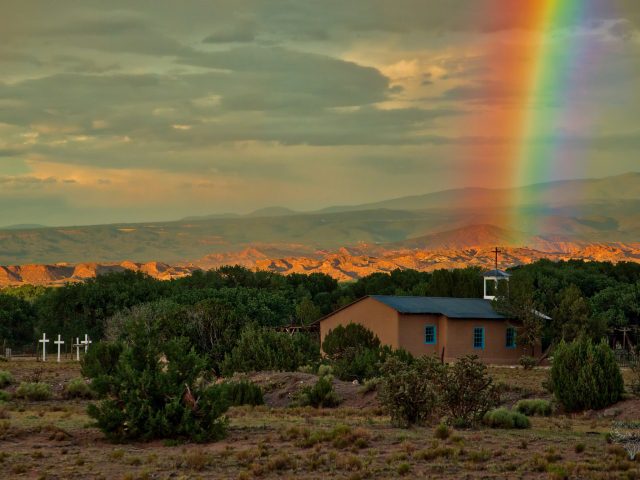 Rainbow over small chapel at San Ildefonso Pueblo, New Mexico.