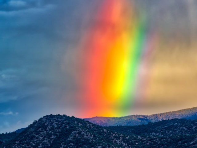 Rainbow underneath a dark cloud