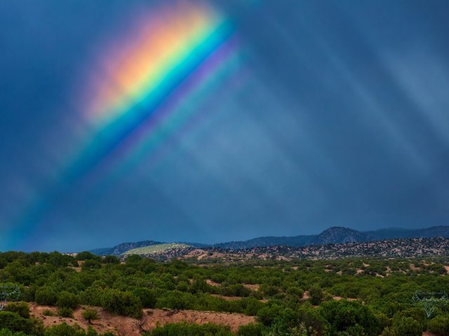 Rainbow with supernumerary bows and anti-crepuscular rays over Santa Fe