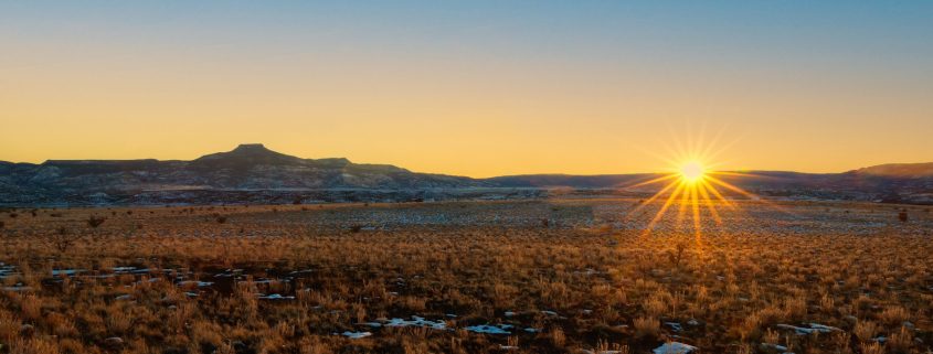 Sun setting on the horizon on Winter Solstice 2020 by Cerro Pedernal, New Mexico