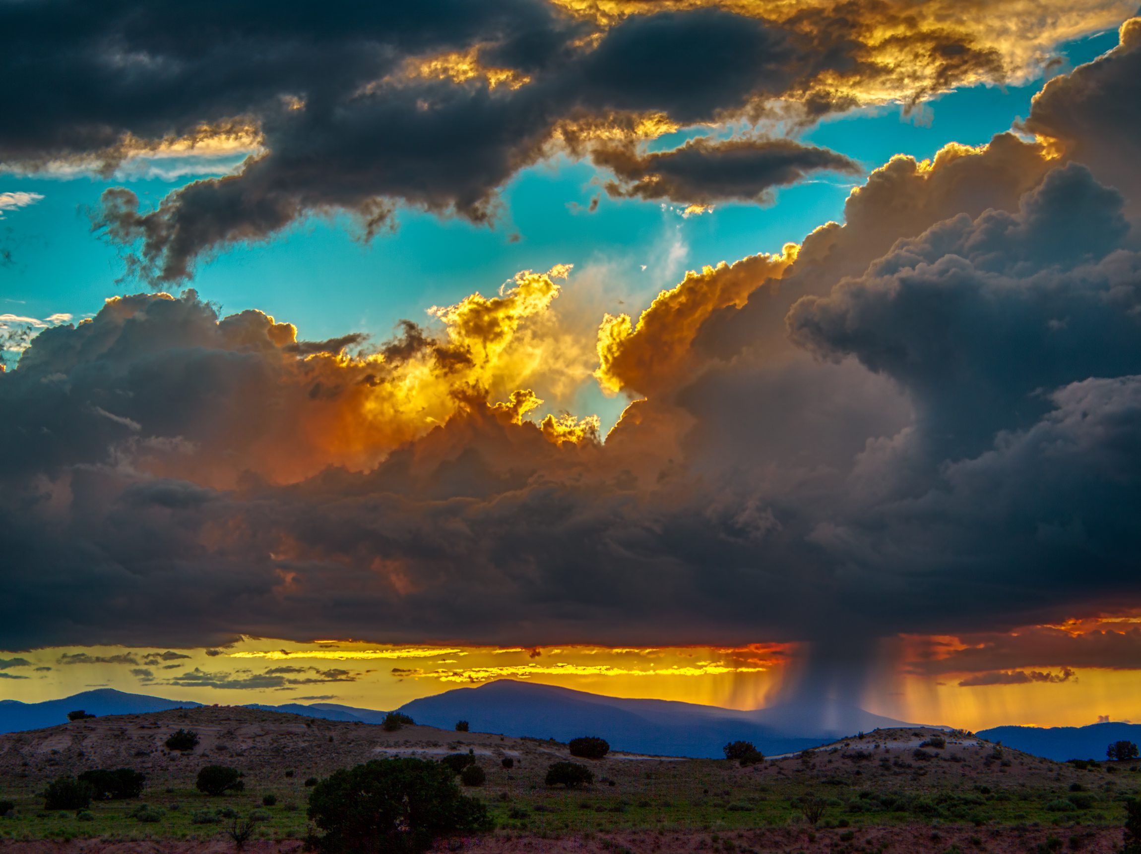 Thunderstorm dumping rain at sunset over the Jemez Mountains, New Mexico.