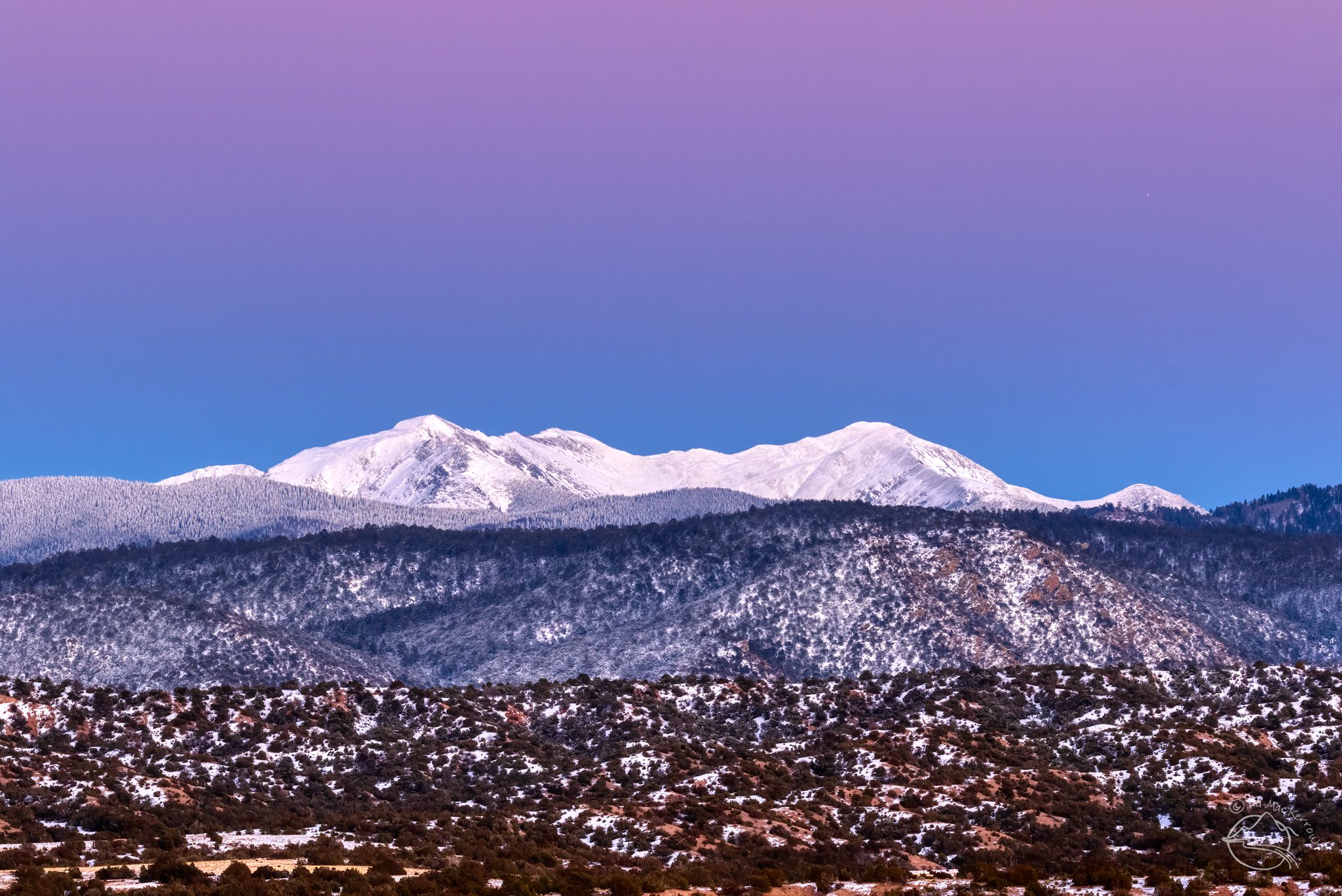 The Truchas Peaks with fresh snow and the Belt of Venus and Earh's shadow.